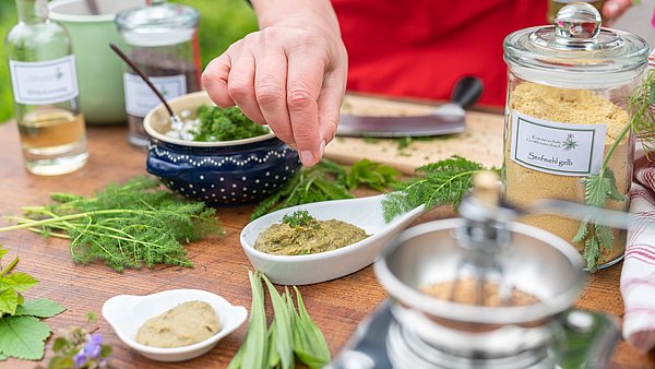 Tisch mit Kräuter und Produkten aus Kräutern